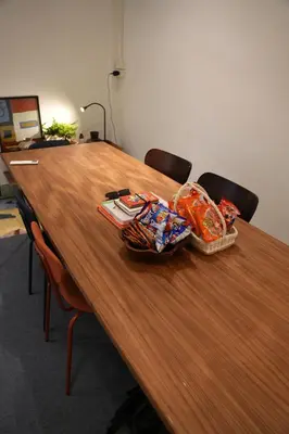 a long wooden table with bags of food on it at Bongo Residence Ratchathewi Bangkok in Bangkok