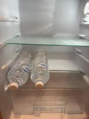 a group of plastic water bottles in a refrigerator at Bongo Residence Ratchathewi Bangkok in Bangkok