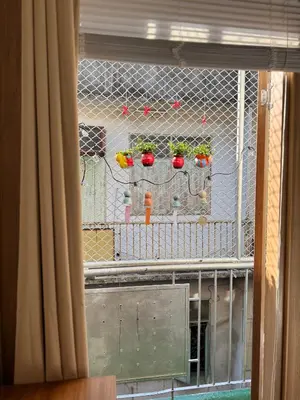 a window with a fence with plants on it at Bongo Residence Ratchathewi Bangkok in Bangkok