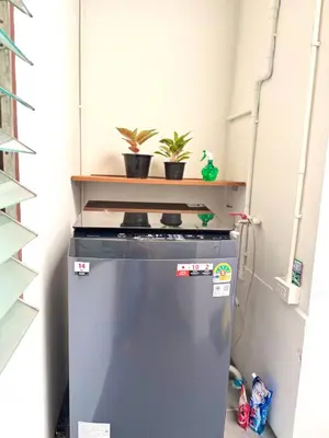 a stove in a kitchen with two potted plants at Bongo Residence Ratchathewi Bangkok in Bangkok