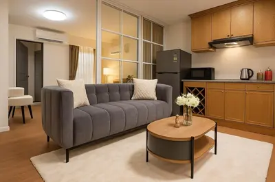 a living room with a couch and a table at Cozy Designer Apartment - Sukhumvit 39 in Bangkok