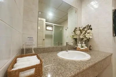 a bathroom with a sink and a mirror at Cozy Designer Apartment - Sukhumvit 39 in Bangkok