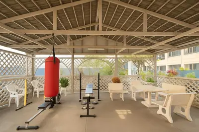 a pavilion with white chairs and tables and a red rocket at Cozy Designer Apartment - Sukhumvit 39 in Bangkok