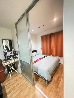 a bedroom with a bed and a glass wall at Lumpini nawamin in Ban Bang Toei (1)