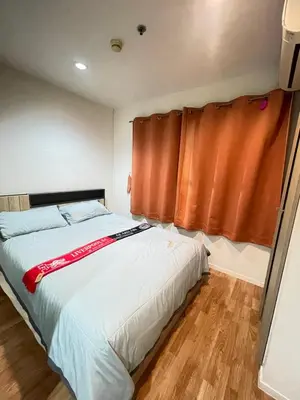 a bedroom with a bed and a window at Lumpini nawamin in Ban Bang Toei (1)