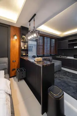 a kitchen and living room with a large island in the middle at Delta 9 Phrakanong in Bangkok
