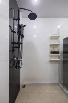 a shower with a glass door in a bathroom at Delta 9 Phrakanong in Bangkok