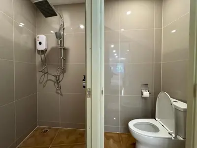 a bathroom with a toilet and a shower in it at Sonata siam-ratchathewi in Bangkok