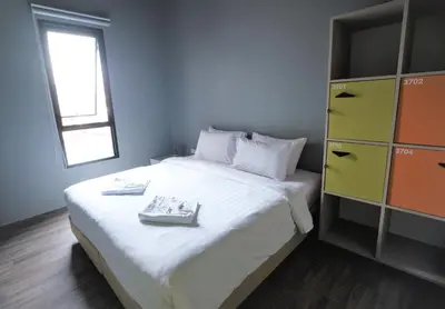 a bedroom with a large bed with two plates on it at iSanook Hostel in Bangkok