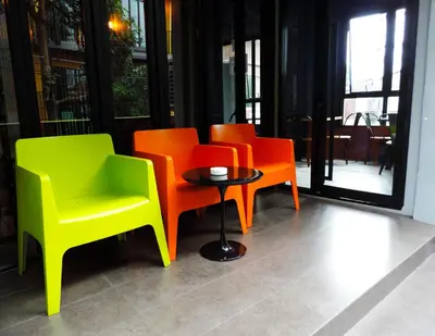 a group of chairs and a table in a room at iSanook Hostel in Bangkok