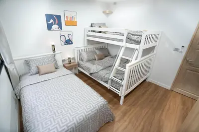 a bedroom with two bunk beds and a bed at Number 31 Bangkok Family in Bangkok