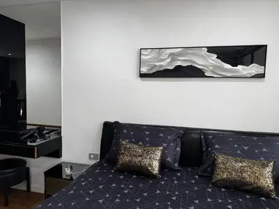 a living room with a couch and a picture on the wall at Number 31 Bangkok Family in Bangkok