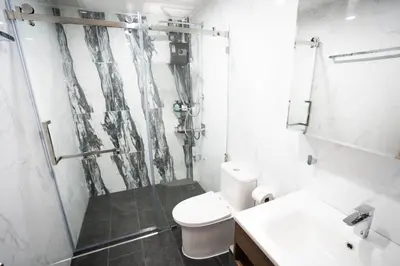 a bathroom with a shower and a toilet and a sink at Number 31 Bangkok Family in Bangkok