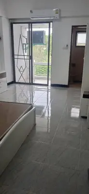 an empty room with a door and a tile floor at Sathitsit Mansion in Bangkok