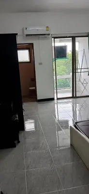 an empty room with a door and a tile floor at Sathitsit Mansion in Bangkok