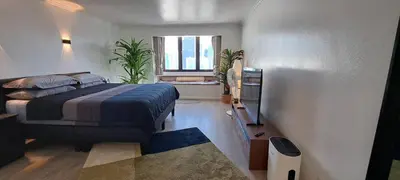 a bedroom with a bed and a window at Stylish New Condo in NANA in Bang Kapi