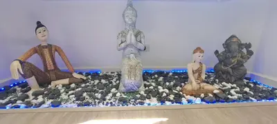 a group of statues sitting on top of a table at Stylish New Condo in NANA in Bang Kapi