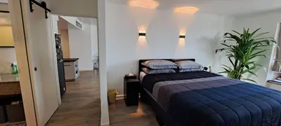 a bedroom with a bed with a blue comforter at Stylish New Condo in NANA in Bang Kapi
