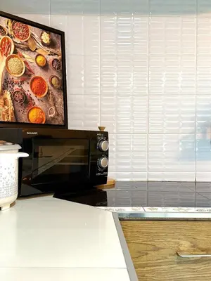 a microwave in a kitchen with a picture of food at Office 3 in Bangkok