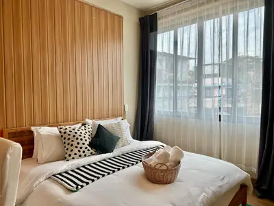 a bedroom with a bed with a basket on it at Office 3 in Bangkok