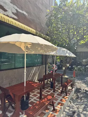 two picnic tables with umbrellas on a patio at office 2 in Bangkok
