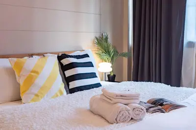 a bedroom with a bed with towels on it at office 2 in Bangkok
