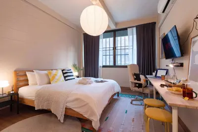a bedroom with a bed and a desk with a computer at office 2 in Bangkok