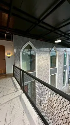 a balcony with a black railing and two windows at Villa Moon Terrace in Bang Khen