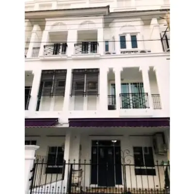 a white building with black doors and windows at Leon Sukhumvit 62 in Bangkok