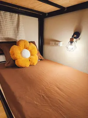 a teddy bear laying on top of a bed at 215-Olan Place Free Wi-Fi and Near BTS line in Sathani Bang Khen