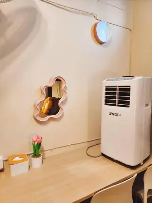 a room with a heater on a table with flowers at 215-Olan Place Free Wi-Fi and Near BTS line in Sathani Bang Khen