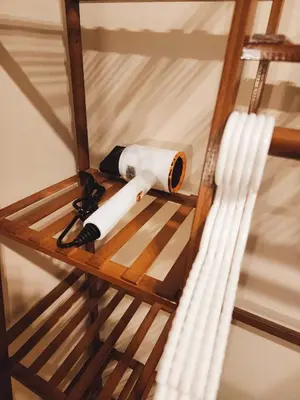 a wooden shelf with some objects on it at 215-Olan Place Free Wi-Fi and Near BTS line in Sathani Bang Khen
