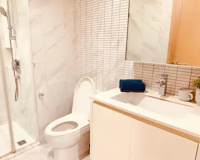 a bathroom with a toilet and a sink and a shower at Stylish Luxury 1 Bedroom, Hyde Sukhumvit 11, Near BTS Nana & Asok in Bangkok