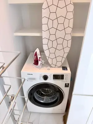 a washer and dryer in a small laundry room at Stylish Luxury 1 Bedroom, Hyde Sukhumvit 11, Near BTS Nana & Asok in Bangkok