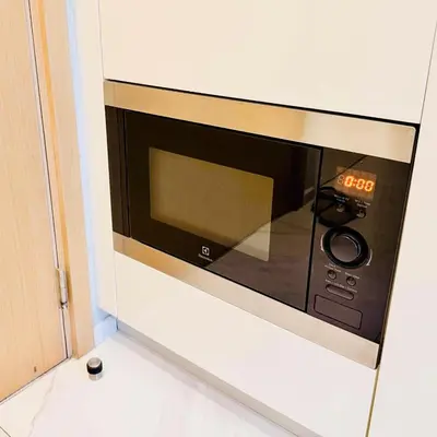 a microwave oven sitting on top of a wall at Stylish Luxury 1 Bedroom, Hyde Sukhumvit 11, Near BTS Nana & Asok in Bangkok
