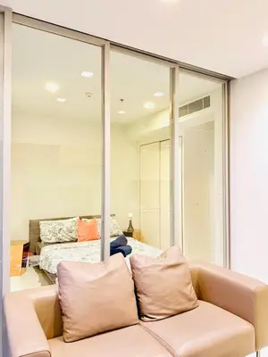 a living room with a couch and a bed at Stylish Luxury 1 Bedroom, Hyde Sukhumvit 11, Near BTS Nana & Asok in Bangkok