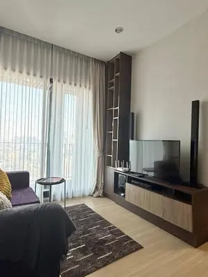 a bedroom with a flat screen tv and a bed at 072-Cap-A-R266-F24 in Ban Na Song