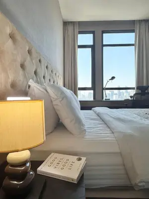 a bedroom with a large bed with a table with a lamp at 072-Cap-A-R266-F24 in Ban Na Song