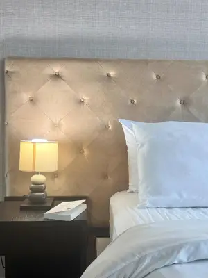 a bedroom with a bed with a night stand with a lamp at 072-Cap-A-R266-F24 in Ban Na Song