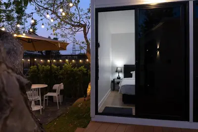 a room with a view of a bedroom with a bed at The Lodge Bangkok Poolvilla 2 in Sathani Khlong Tan