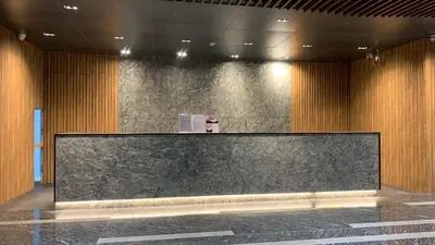 a large screen in a room with wooden walls at Bangkok City Rama 9 Hotel in Bangkok