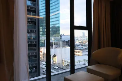 a room with a window with a view of a city at Bangkok City Rama 9 Hotel in Bangkok