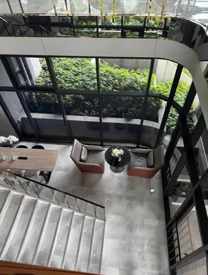 a view from the top of a building with tables and chairs at Bangna Apartment Ideo in Ban Khlong Samrong