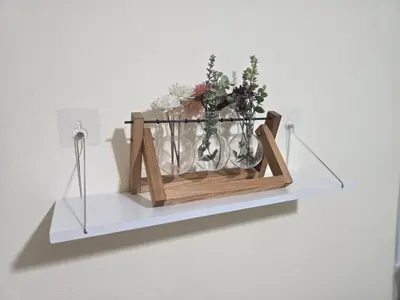 a shelf with flowers and vases on a wall at 114 Boutique style apartment with Air Con and free Wi-fi in Bangkok