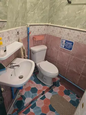 a bathroom with a toilet and a sink at 114 Boutique style apartment with Air Con and free Wi-fi in Bangkok