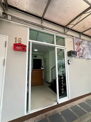 an entrance to a building with a sliding glass door at Minimal condo 5 mins to mrt Suthisarn in Bangkok