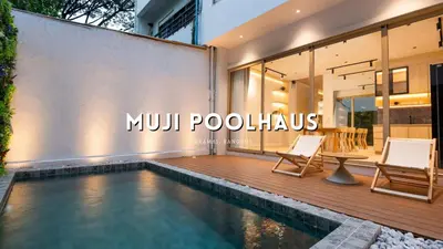 a swimming pool in front of a house at Spacious 4BR Muji Home with Loft Pool in Ekkamai in Bangkok