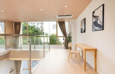 a room with a desk and a table and a chair at Spacious 4BR Muji Home with Loft Pool in Ekkamai in Bangkok