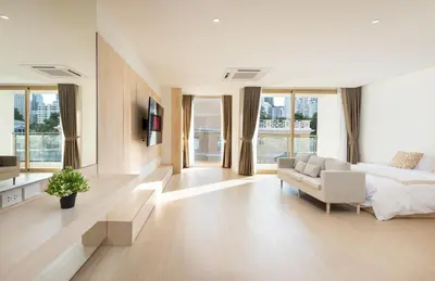 a living room with a bed and a couch at Spacious 4BR Muji Home with Loft Pool in Ekkamai in Bangkok