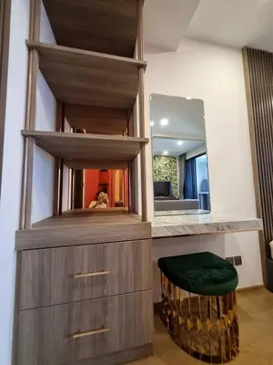 a bathroom with a vanity with a mirror and a stool at Ashton Mrt At Bts-Silom Near samyan mitrtown in Bangkok